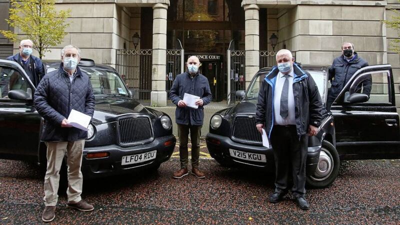 West Belfast MP Paul Maskey with taxi drivers representatives handing a letter into the Department for Infrastructure recently to highlight their plight. Picture by Mal McCann. 