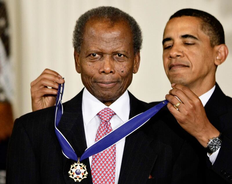 President Barack Obama presents the 2009 Presidential Medal of Freedom to Sidney Poitier in the East Room at the White House in Washington on August 12 2009