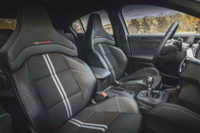 The interior features large bucket seats