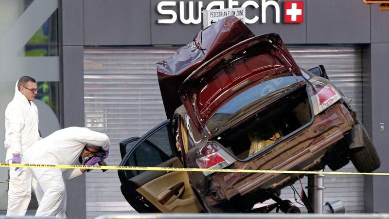 Investigators photograph evidence at the scene of a crash that killed one person and injured almost two dozen others in Times Square. Picture by Kathy Willens, Associated Press 