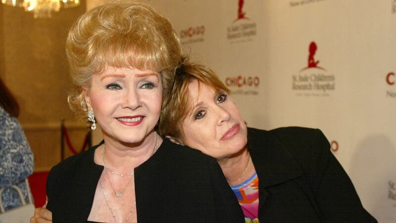 Debbie Reynolds, left, and Carrie Fisher arrive at the Runway for Life  Celebrity Fashion Show Benefitting St Jude's Children's Research Hospital in California in 2013. Picture by Jill Connelly, Associated Press&nbsp;