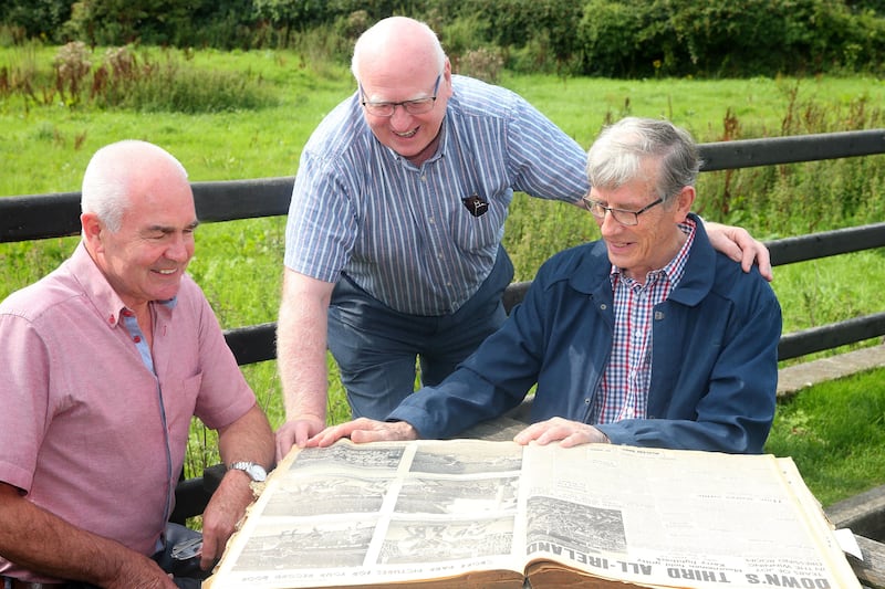 Mickey Cole, Peter Rooney and Dan McCartan look over the Irish News file from September 22, 1968 - the day they helped Down to a third All-Ireland title that decade. Picture by Mal McCann