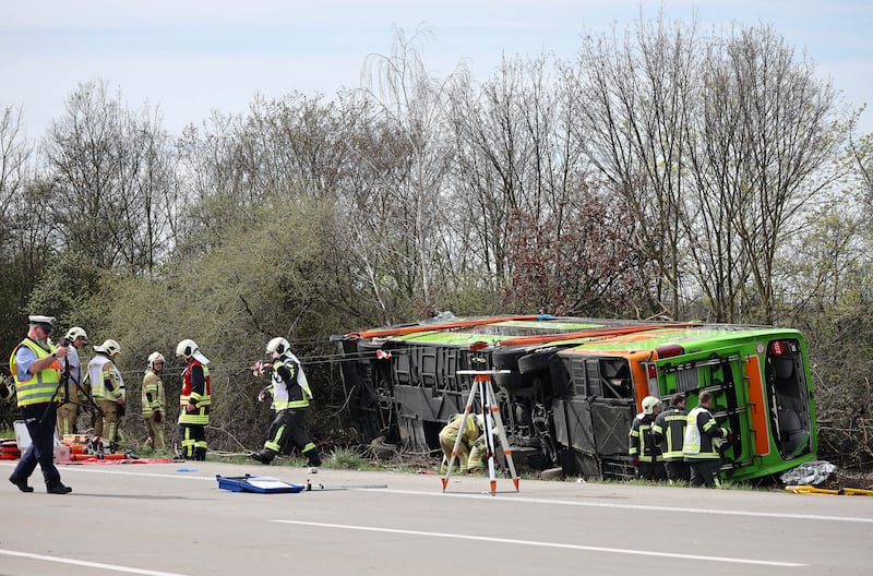 A coach lies overturned on its side at the scene of an accident on the A9, near Schkeuditz, Germany (Jan Woitas/dpa via AP)