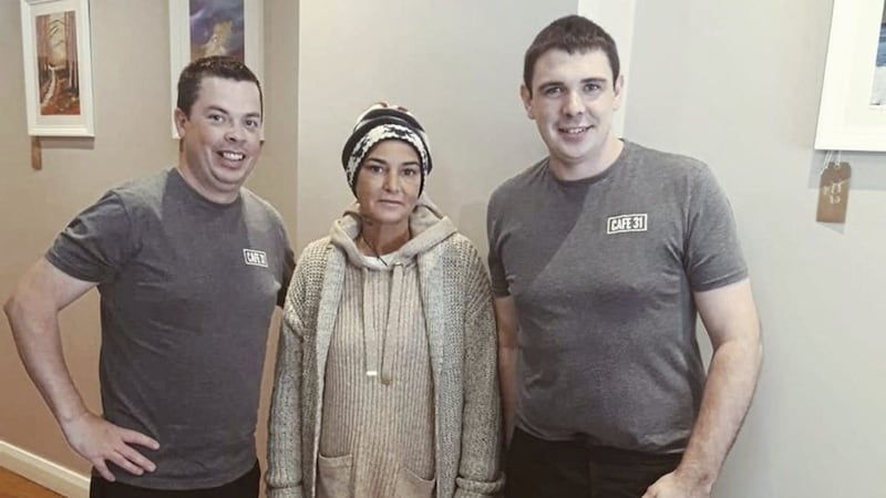 Singer Sinead O&#39;Connor pictured yesterday with Sean Roberts, who owns Cafe 31 on Market Street in Downpatrick and head chef, Marc Lavery 