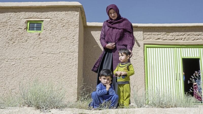 A 30-year-old mother and beneficiary of a cash distribution programme, with two of her children in Daykundi Province, Afghanistan on May 28 