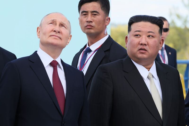 Vladimir Putin and Kim Jong Un examine a launch pad of Soyuz rockets during their meeting
