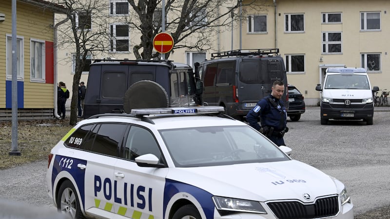 Police officers and vehicles at the scene of Viertola comprehensive school, in Vantaa, Finland where three children were wounded in a shooting (Markku Ulander/Lehtikuva via AP)