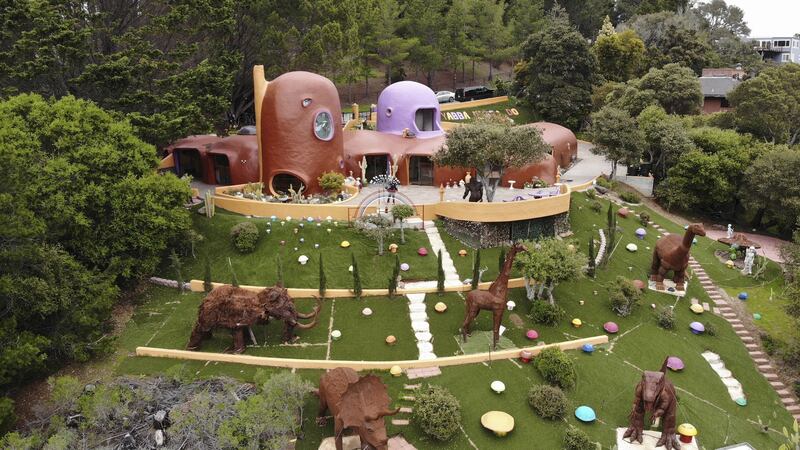 The new owner added dozens of colourful mushroom sculptures and a herd of life-size dinosaurs.
