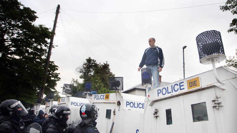 Police on Twaddell Avenue in north Belfast. Policing and justice accounts for around half the cost of division in the north. Picture by Gerard Black