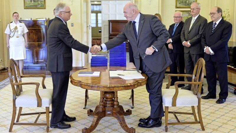 Commissioner Justice Peter McClellan, second left, shakes hands with governor-general of Australia Peter Cosgrove, fourth right, at the signing ceremony and the release of the final report of the Royal Commission into Institutional Responses to Child Sexual Abuse at Government House, in Canberra PICTURE: AP 