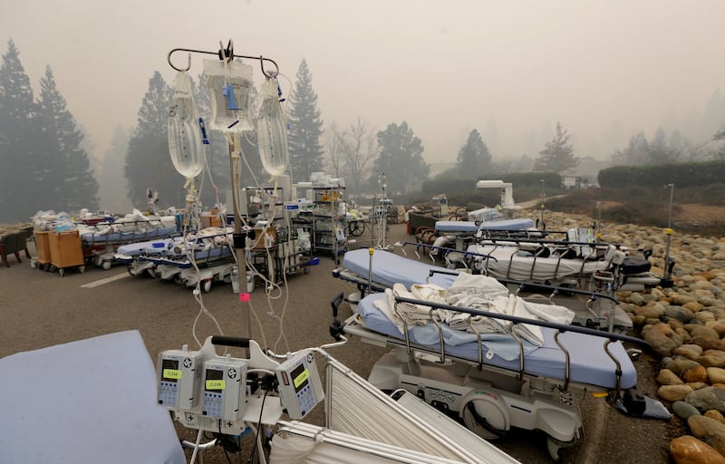 Hospital beds and other equipment sit in a parking lot outside the Feather River Hospital