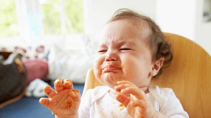 Although it will likely upset your inner clean fiend, babies need to handle food when weaning 