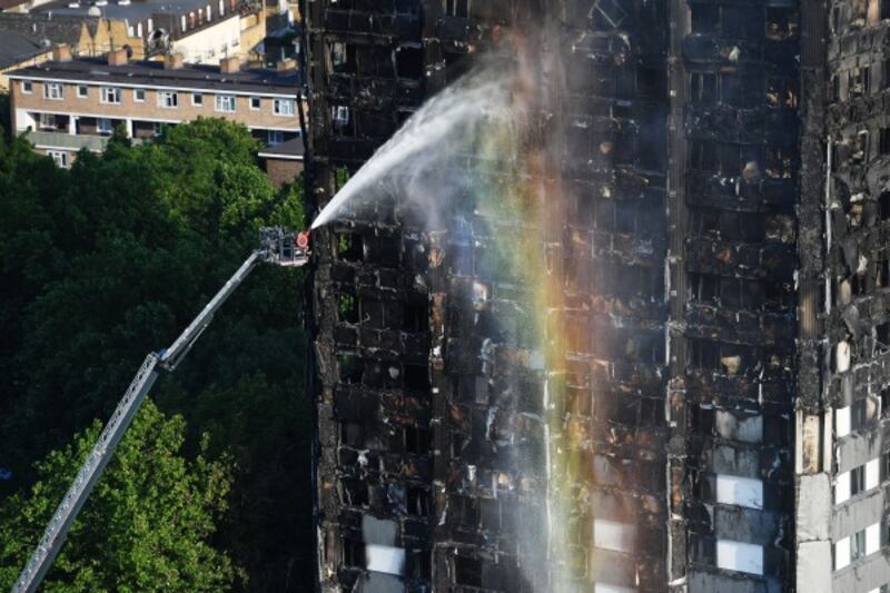Firefighters spray water on the building (Victoria Jones/PA)