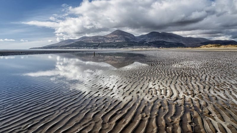 Murlough Beach looking towards Newcastle, Co Down, with Slieve Donard and the Mourne Mountains towering over the town 