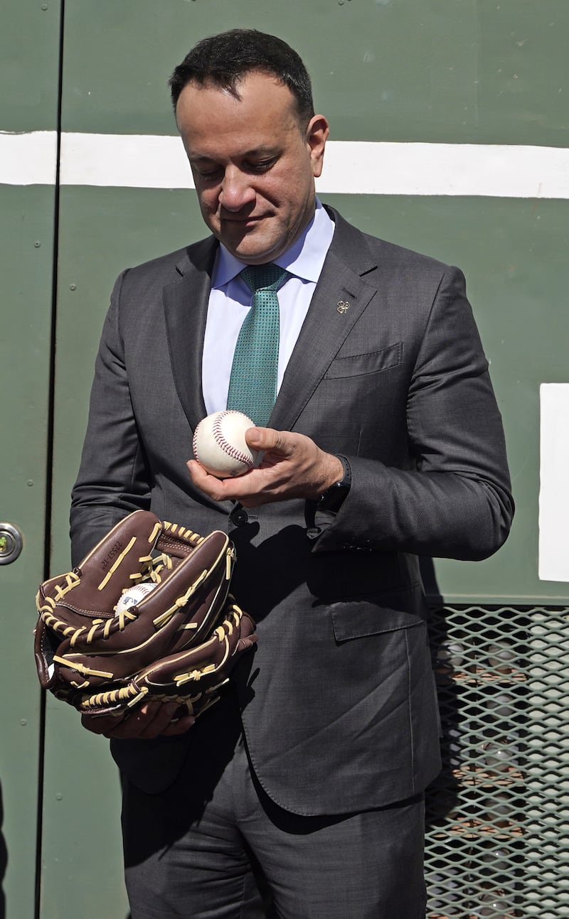 Taoiseach Leo Varadkar is presented with a ball and mitts