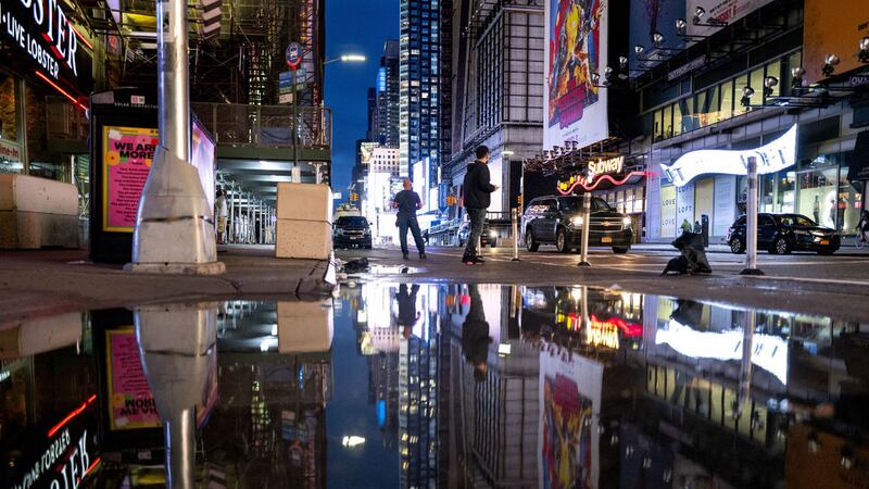 The lights of Times Square in New York are reflected in standing water Thursday, Sept 2, 2021, as Hurricane Ida left behind not just water on city streets but wind damage and severe flooding along the Eastern seaboard (AP Photo/Craig Ruttle)&nbsp;