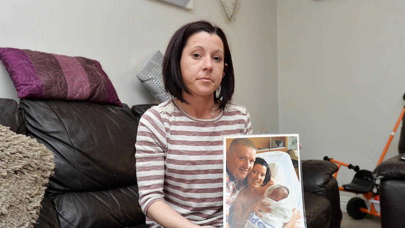 Ciara Austin holds a picture of her partner Dan Murray taken on the day of the birth of their son Padraig. Picture by Mal McCann 