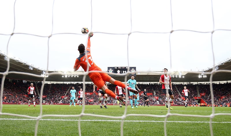 Southampton's goalkeeper dives for the ball against Bournemouth