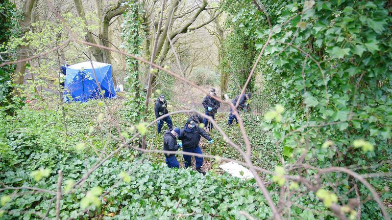 Police officers search by a forensic tent at Kersal Dale, near Salford, Greater Manchester