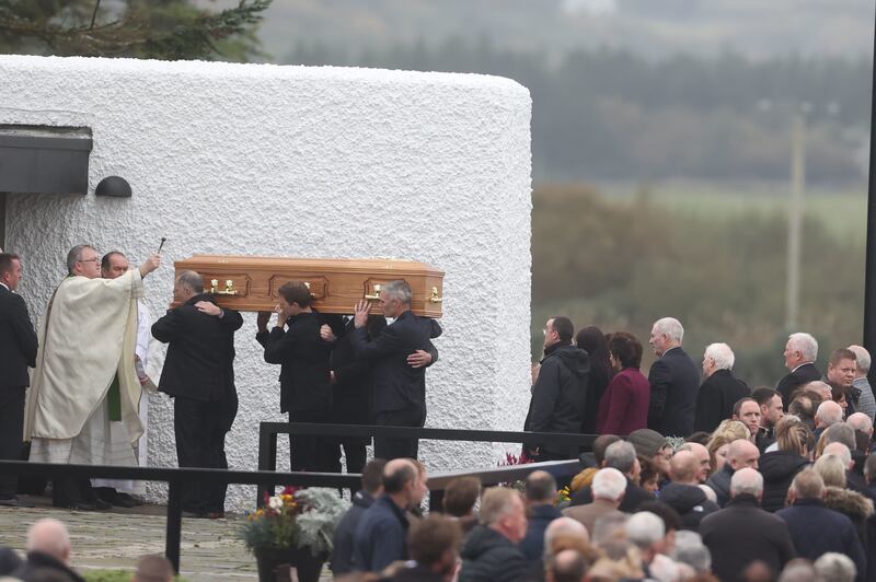 Priest Fr John Joe Duffy sprinkles holy water on the coffin of Martin McGill, 49, as it arrives at St Michael's Church, Creeslough, for his funeral Mass. Picture by Liam McBurney/PA Wire