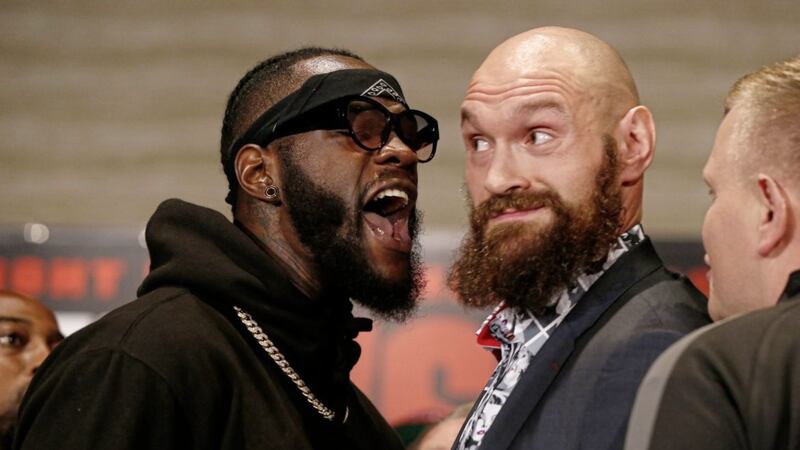 Boxers Deontay Wilder, left, and Tyson Fury exchange words as they face each other at a news conference in Los Angeles on Wednesday 