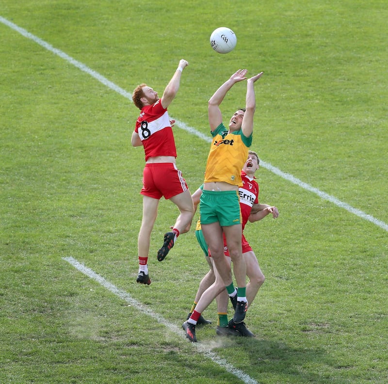 Derry's Conor Glass challenges for the ball with Donegal's Jason McGee     Picture: Margaret McLaughlin