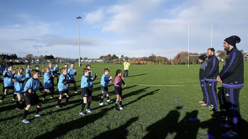 Club members of Seapoint Rugby Club, Co. Dublin, perform a Haka for All Blacks (from left) Aaron Smith, Joe Moody, and Sam Whitelock during a rugby minis masterclass, in support of UNICEF&acirc;??S right to play campaign. Photo by PA