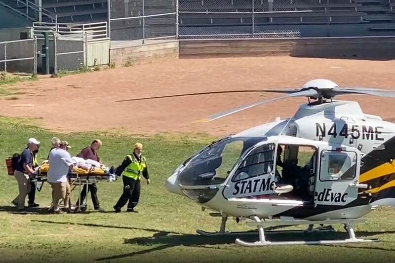 Sir Salman is taken on a stretcher to a helicopter for transport to a hospital 