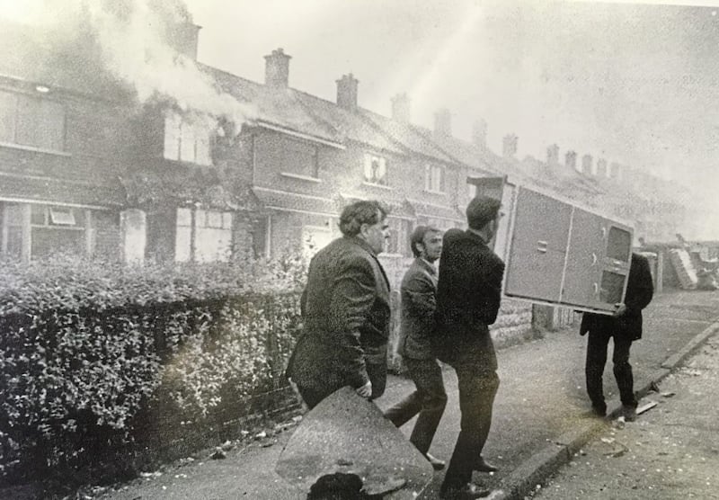 People flee their homes in Farringdon Gardens in Ardoyne in August 1971. It was one of the streets in the area where loyalists burned Protestants out of their homes to stop Catholic families from moving in. Catholics were forced out of other mixed areas at the time. Fr Fernando - a builder before becoming a Passionist - is fondly remembered for his hands-on approach to building new homes. Picture from Holy Cross Ardoyne, 1869-2019 