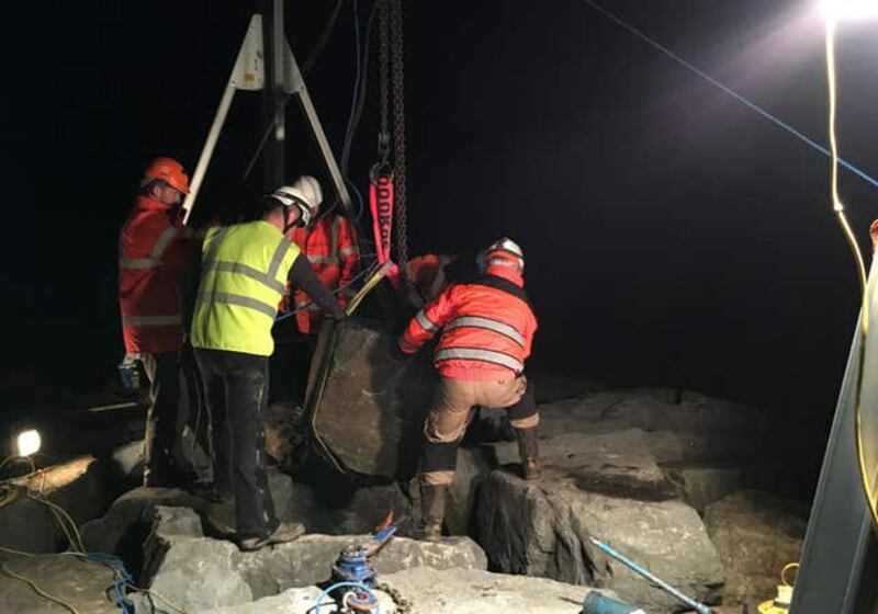 A seal pup being rescued from under a one-tonne boulder near Port Talbot steelworks in South Wales