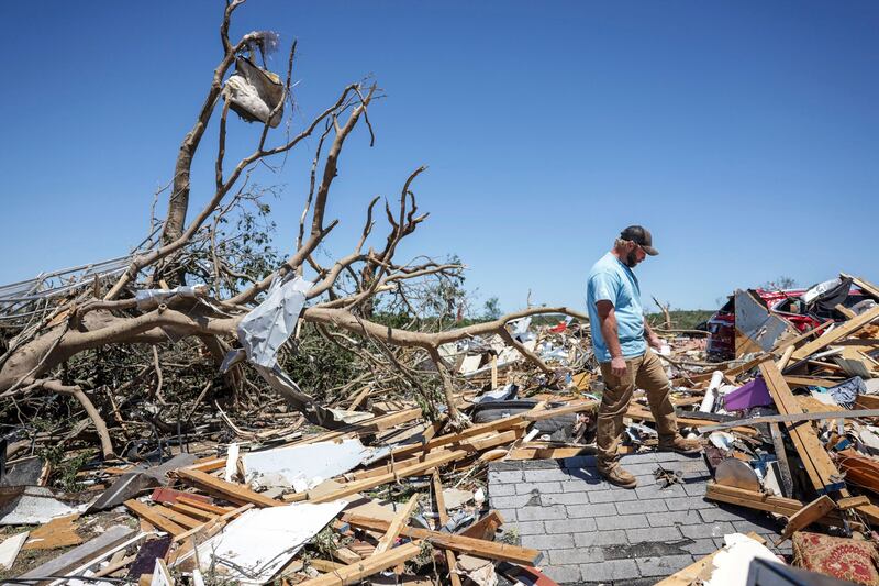 Paden Fincher looks to salvage items from what is left of his sister’s home following a severe storm in Barnsdall (Mike Simons/Tulsa World via AP)