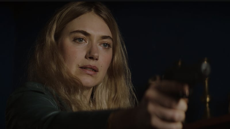 Imogen Poots pointing a gun in a scene from the movie Baltimore