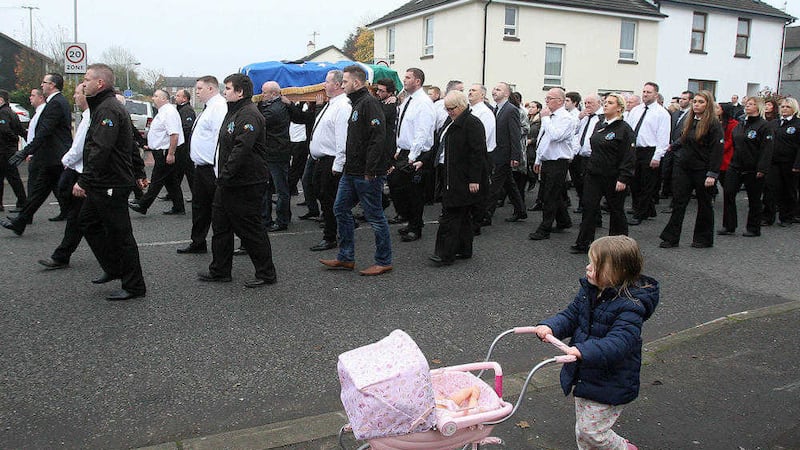 A young child walks along side as the funeral of Co Derry republican Declan McGlinchey makes it way through Bellaghy&nbsp;