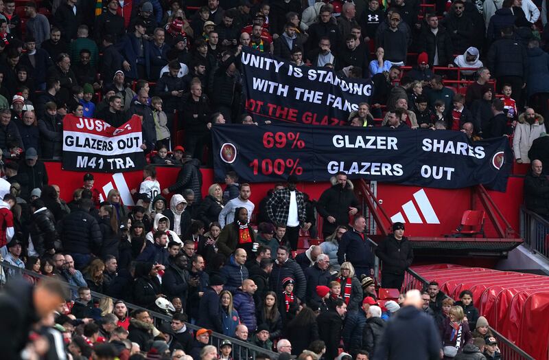 Manchester United fans with protest banners against the Glazer family’s ownership, pictured during the match against Luton in November