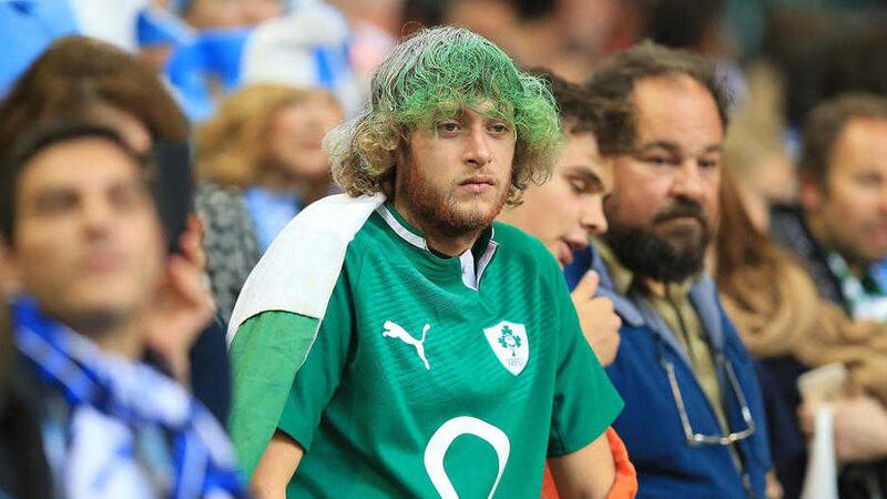 A disappointed fan contemplates Ireland's defeat in the Rugby World Cup to Argentina