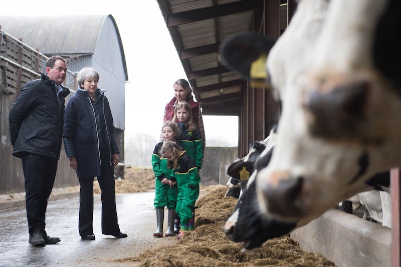 Prime Minister Theresa May is shown around Fairview Farm by owners Stephen and Susanne Jackson and their three daughters Hannah, Abbie and Emily&nbsp; in Bangor, Northern Ireland during a tour of the four nations of the UK, with a promise to keep the country united one year before Brexit. Stefan Rousseau/PA Wire