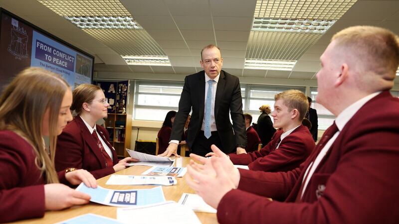 Secretary of State Chris Heaton-Harris with pupils from Ulidia Integrated College