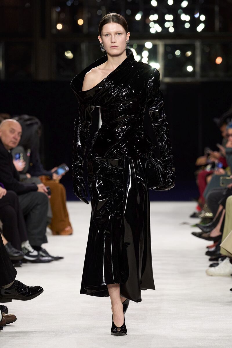Model on catwalk wearing black pvc maxi dress, Balmain