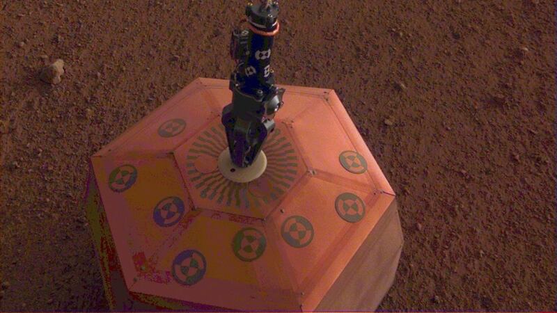 It is the first time a robotic arm has lowered an experiment on to the Martian surface.