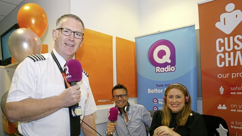 EasyJet Captain Martin Doddy welcomes listeners on board for the airline&#39;s 20th Birthday Q Radio Breakfast broadcast with presenters Stephen Clements and Cate Conway 