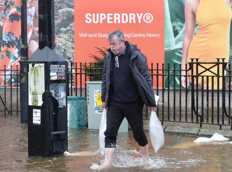 Peter Johnston tries to protect his business on Canal Street, Newry. PICTURE MAL MCCANN