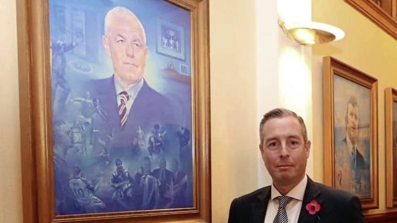 First Minister Paul Givan beside a portrait of late Rangers&#39; manager Waler Smith inside Ibrox 