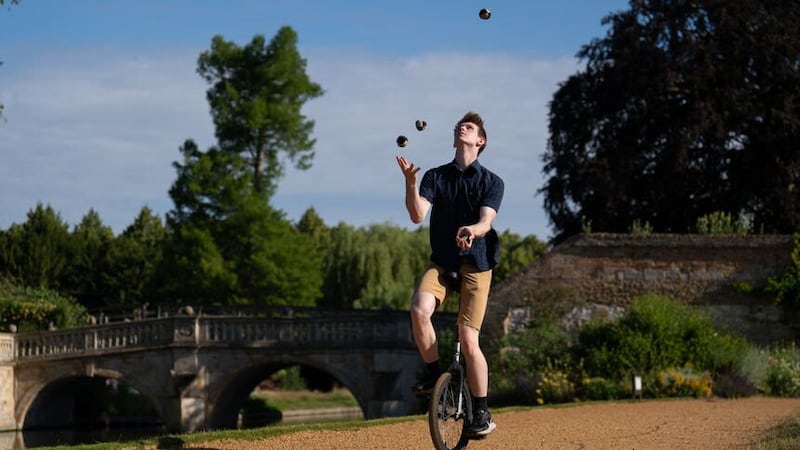 Cambridge University student James Cozens has equalled a Guinness World Record for ‘the most objects juggled while riding a unicycle’, achieving a total of seven balls for a period of 16.77 seconds (Joe Giddens/PA)
