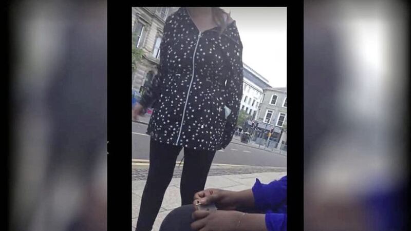 A still from a video showing three teenage girls being racially abused by a woman 