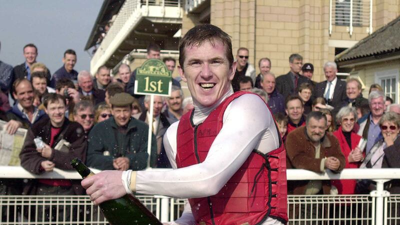 Tony McCoy celebrates by spraying champagne after notching his 270th win of the season at Warwick racecourse on Tuesday April 2 2002 and breaking Sir Gordan Richards's long-standing record of 269 wins in a season