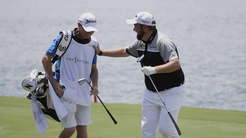&nbsp;Shane Lowry reacts to his shot from the 18th fairway with his caddie Dermot Byrne, during the first round of The Players Championship golf tournament<br />Picture by AP