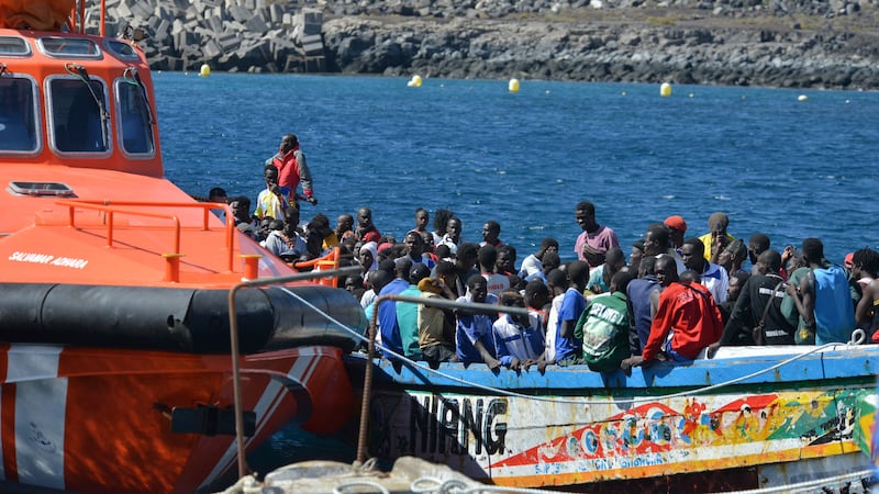 Migrants wait to disembark from a small boat in La Restinga on the Canary Island of El Hierro (Europa Press via AP)