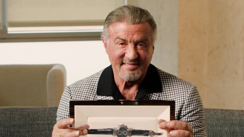 Sylvester Stallone with one of his watches being auctioned