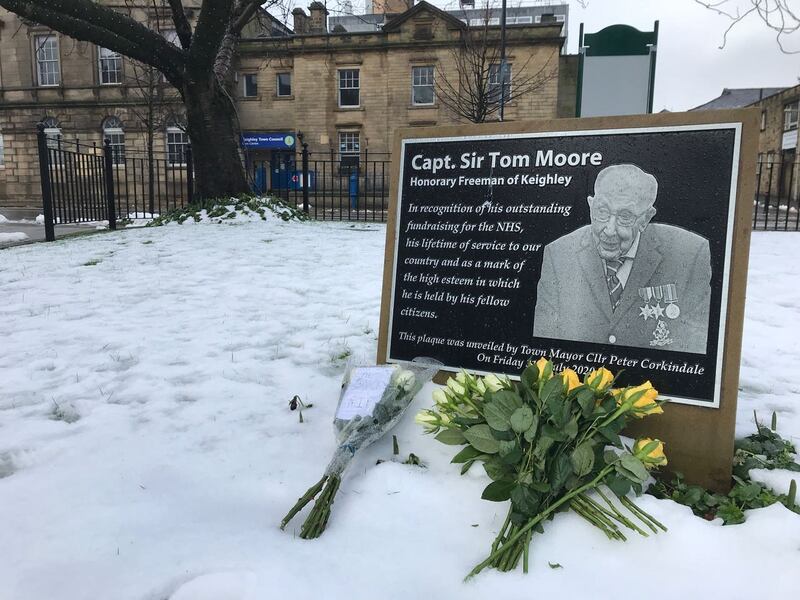 Tributes at the plaque in Town Hall Square, Keighley in tribute to 100-year-old charity fundraiser Captain Sir Tom Moore who died on Tuesday after testing positive for Covid-19
