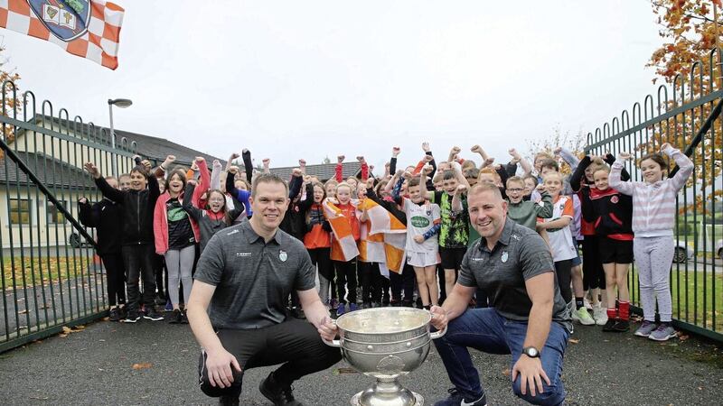 Jason McGahan and Colin Trainor on the way into Our Lady&#39;s Primary School in Tullysaran with the Sam Maguire Picture: Hugh Russell. 